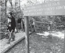  ??  ?? Kamden McArthur, 8, of Imperial, Missouri, and Lynne Gonzalez, 56, of Prairie du Rocher, Illinois, walk out of the Illinois Caverns in Waterloo on July 15. The caverns have been closed for a decade because of fears of spreading a fungus. They just reopened last week to tourists.