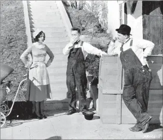  ?? File photo ?? “THE MUSIC BOX” (1932), starring Stan Laurel, center, and Oliver Hardy as furniture movers dealing with a piano and a daunting f light of stairs, will screen Saturday with “Jitterbugs” (1943).