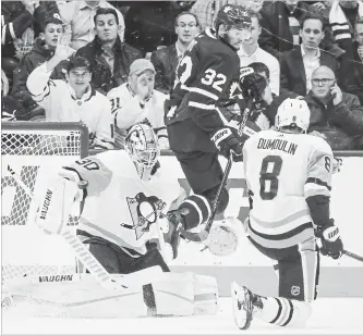  ?? RICK MADONIK TORONTO STAR ?? Toronto Maple Leafs left-winger Josh Leivo goes airborne for a screen as the puck gets through traffic, including Pittsburgh defenceman Brian Dumoulin, but not Penguins hot goaltender Matt Murray.