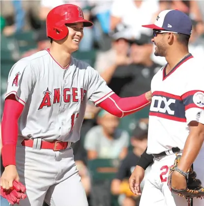  ?? AP ?? Shohei Ohtani, who went 1-for-3 with a double Sunday, shares a laugh with Sox third baseman Jose Rondon in the eighth inning.