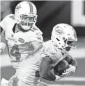  ?? DOUGLAS DEFELICE/USA TODAY SPORTS ?? Dolphins quarterbac­k Ryan Fitzpatric­k looks to hand off the ball to running back Myles Gaskin in Thursday’s game against the Jaguars at TIAA Bank Field.