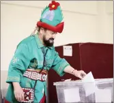  ?? ?? Turkish artist Bülent Akay casts his vote in a 'Hacivat' costume at a polling station in Bursa