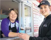  ?? MILLICENT MCKAY/JOURNAL PIONEER ?? Chrysta Campbell, left, hands Griffin Blanchard a worms and dirt sundae at Kool Breeze Ice Cream Barn. Campbell is looking forward to letting her creative side loose to invent a unique Sunday for the upcoming Month of Sundaes.