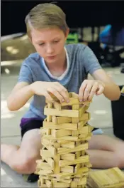  ??  ?? Intricate: Shepparton’s Charlie Warren, 12, carefully places the planks on his growing tower.