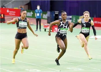  ?? - AFP photo ?? Asher-Smith (centre) wins the women's 60m event ahead of France's Orlann Ombissa-Dzangue (left) and Switzerlan­d's Aula Del Ponte.