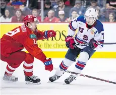  ?? DARRYL DYCK/THE CANADIAN PRESS ?? Quinn Hughes, right, who has starred for the U.S. national team and the NCAA’s Michigan Wolverines, is confident he can be a starring player for the Vancouver Canucks, too.