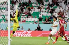  ?? AFP ?? Senegal’s forward Famara Diedhiou (R) looks on as Qatar’s goalkeeper Meshaal Barsham is unable to stop his header, as he scores his team’s second goal during their World Cup Group A match on Friday.