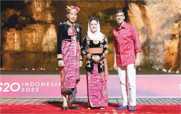  ?? Associated Press ?? Indonesian President Joko Widodo (left) and his wife Iriana Widodo welcome British Prime Minister Rishi Sunak during the G20 Leaders’ Summit in Bali, Indonesia, on Tuesday.