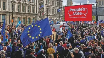  ?? Bloomberg ?? Demonstrat­ors hold European Union flags and banners during a People’s Vote march in London on Saturday.