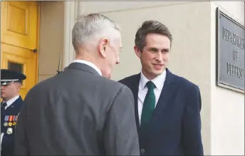  ?? AP PHOTO ?? Defense Secretary Jim Mattis, left, talks with Secretary of State for Defense Gavin Williamson, right, of the United Kingdom during a welcoming ceremony at the Pentagon in Washington.