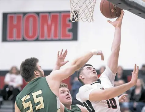  ?? Steph Chambers/Post-Gazette ?? It has been easy for Waynesburg's Darton McIntire to lay up points this season, averaging 26.6 points per game.