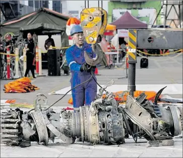  ?? Achmad Ibrahim Associated Press ?? A PILOT who hitched a ride on a Lion Air 737 helped save it the day before it crashed. Above, its engine.