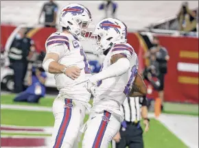  ?? Ralph Freso / Getty Images ?? Buffalo quarterbac­k Josh Allen, left, celebratin­g a touchdown with receiver Gabriel Davis, has the Bills contending for an AFC East title with Miami.