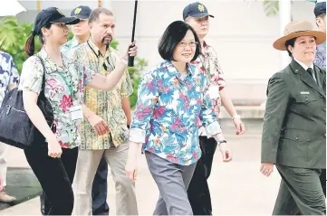  ??  ?? Tsai (centre), on transit enroute to Pacific island allies, visits the USS Arizona memorial at Pearl Harbor near Honolulu, Hawaii. — Reuters photo