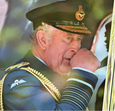  ?? ?? Serious: The King returns to Buckingham Palace after yesterday’s ceremonies