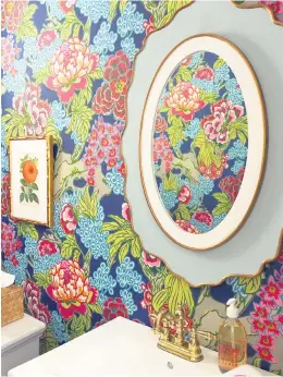  ?? Kate Smith Interiors ?? Colorful wallpaper makes a dramatic statement in this powder room designed by Kate Smith, owner of Kate Smith Interiors.