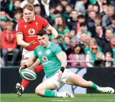  ?? — AFP photo ?? Wales’ fly-half Sam Costelow (left) vies with Ireland’s wing Calvin Nash during the Six Nations internatio­nal rugby union match between Ireland and Wales at the Aviva Stadium in Dublin.