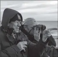  ?? The Washington Post/ANDREW TESTA ?? John Lees (left) and Garry Bagnell observe a rarely sighted shorelark in Great Yarmouth, England, in early December. “When a bird you haven’t seen drops, you’ve got to chase it,” Bagnell said.