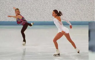  ??  ?? LEFT: Tonya, left, and Nancy Kerrigan during a practice session at the 1994 Lillehamme­r Olympics. BELOW: An upset Tonya explains the broken boot lace that marred her Olympic performanc­e.