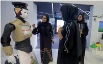  ?? Photos by Dhes Handumon ?? Visitors interact with the Dubai Police Robot at the Dubai Police pavilion.—