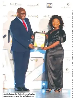  ?? ?? Ms Kudakwashe Chiutsi receiving her award from one of the adjudicato­rs