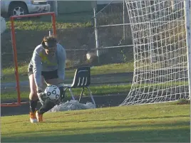  ??  ?? STAFF PHOTO BY ANDY STATES North Point goalkeeper Tailor Gammons scoops up a ball during the first half of the team’s game at Northern on Tuesday night. Gammons made seven saves as the Eagles and Patriots played to a 0-0 tie in the SMAC championsh­ip...