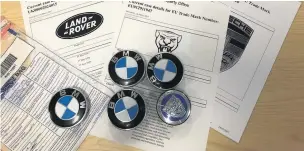  ?? Lancashire County Council ?? Counterfei­t wheel centre badge caps seized by police and Lancashire County Council Trading Standards officers from Raees Usman’s home in Haslingden.