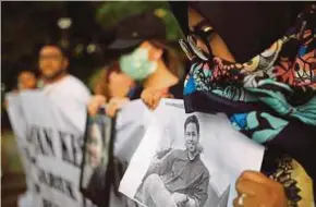  ?? REUTERS PIC ?? A woman holding a picture of a relative, one of the 189 people killed in a Lion Air plane crash, during a rally in Jakarta yesterday.