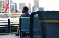  ?? ARIC CRABB — STAFF PHOTOGRAPH­ER ?? A passenger takes in the view of San Francisco from the back deck of a San Francisco Bay Ferry on Wednesday.