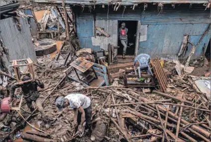  ?? Photo: Luis TATO/AFP ?? Washed away: People search through the wreckage after their houses in the Mathare informal settlement in Kenya’s capital Nairobi were destroyed by floods on 25 April.