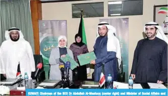  ??  ?? KUWAIT: Chairman of the IICO Dr Abdullah Al-Maatouq (center right) and Minister of Social Affairs and Labor Hind Al-Sabeeh (center left) pose for a picture after signing the agreement yesterday. —KUNA