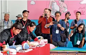  ??  ?? Journalist­s from home and abroad visit the vocational education and training center in Moyu county of Hotan Prefecture, northwest China’s Xinjiang Uygur Autonomous Region, July 20, 2019. (Xinhua/ma Kai)