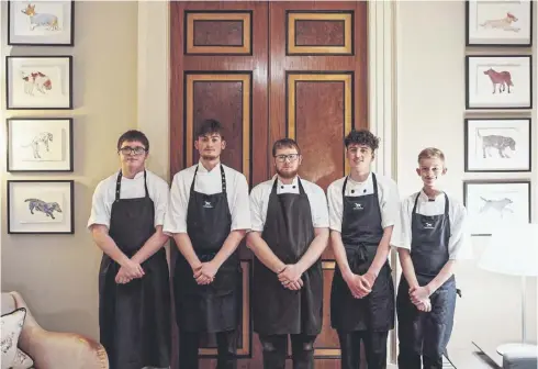  ?? ?? Apprentice­s prepare a superb meal at The Kennels at Goodwood.