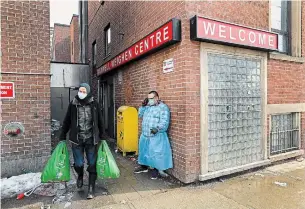  ?? NATHAN DENETTE THE CANADIAN PRESS ?? A worker at Maxwell Meighen Centre in Toronto helps a homeless man as COVID variants have spread among the homeless. Vaccinatio­ns in population­s considered high-risk are ongoing.