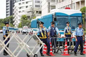  ??  ?? Police officers stand guard near the headquarte­rs of the General Associatio­n of Korean Residents in Japan (Chongryon), in Tokyo after North Korea fired a missile. — Reuters photo