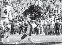  ?? John E. Moore III / Getty Images ?? Texas Tech’s SaRodorick Thompson runs for a touchdown during the first half of Saturday’s game at Lubbock.