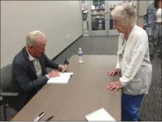  ?? PEG DEGRASSA - MEDIANEWS GROUP ?? Laura Bruni, right, of Drexel Hill, formerly of South Philadelph­ia, gets her book signed as she reminisces about the “good old days” in the neighborho­od with entertaine­r Bobby Rydell, also a native of South Philly.