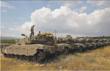  ?? Jalaa Marey / AFP / Getty Images ?? Israeli tanks take position near the Syrian border in the Israeli-annexed Golan Heights. Israel attacked suspected Iranian targets in Syria that it said were in response to an Iranian rocket barrage on Golan.