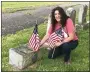  ??  ?? For Memorial Day, Bronwyn DeMaso, a board member of Edgewood Cemetery, places a flag at veteran’s headstone Sunday.