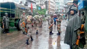  ??  ?? Army jawans on patrol in Darjeeling town on Sunday before the funeral procession of two people who had died in the police firing on Saturday. — PTI