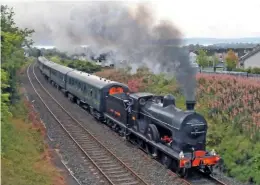  ?? CHARLES FRIEL ?? gnr(i) ‘Q’ 4-4-0 no. 131 climbs the 1-in-76 monkstown bank above bleach green Junction with the ‘portrush Flyer’ on august 12.