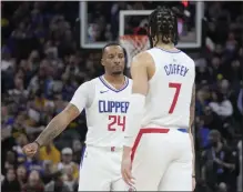  ?? JEFF CHIU — THE ASSOCIATED PRESS ?? The Clippers’ Norman Powell (24) celebrates a play with Amir Coffey during Wednesday night’s victory over the Warriors in San Francisco.