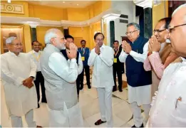  ??  ?? Prime Minister Narendra Modi is being greeted by Chief Ministers Shivraj Singh Chouhan of Madhya Pradesh (2nd from right), Raman Singh of Chhattisga­rh (3rd right), and K. Chandrasek­har Rao of Telangana (4th right) as Nitish Kumar of Bihar (left) and Manohar Lal Khattar of Haryana (right) look on at a Niti Aayog meet in New Delhi on Sunday. — DC