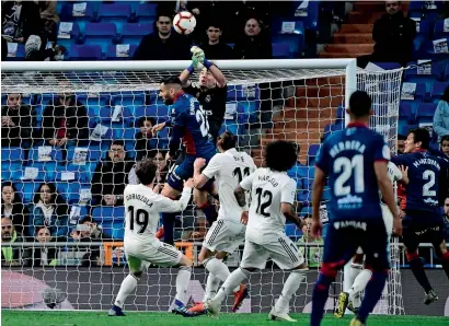  ??  ?? Real Madrid goalkeeper Luca Zidane (centre) blocks a shot on goal during the La Liga match against Huesca. —