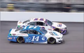  ?? Doug McSchooler / Associated Press ?? Chase Briscoe (14) and Denny Hamlin (11) battle for track position during a restart at Indianapol­is Motor Speedway on Sunday.