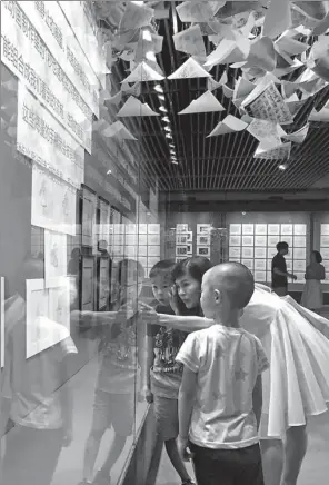  ?? PROVIDED TO CHINA DAILY ?? Clockwise from right: Visitors in front of the original scripts of the animation film Sleeping Beauty. The exhibition offers a section for visitors to produce their own cartoon WANG KAIHAO / CHINA DAILY works. Exhibits on classic Japanese animation....