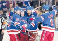  ?? FRANK FRANKLIN II/AP ?? The Rangers’ Chris Kreider (20) celebrates with teammates K’andre Miller (79) and Jacob Trouba (8) after scoring a goal during the second period against the Penguins on Thursday in New York.