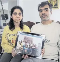  ?? JASON MILLER TORONTO STAR ?? A grieving Manant Vaidya and his wife, Hiral, hold a recent family photograph that includes several members of their Brampton-based family who died in the Ethiopian Airlines crash on Sunday.