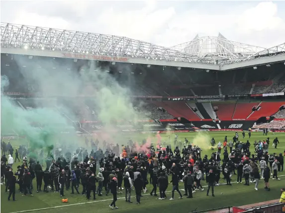  ?? Reuters ?? Manchester United fans on the Old Trafford pitch protesting against the club’s American owners hours before the match against Liverpool was due to kick-off