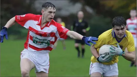  ??  ?? Diarmuid Kehoe of Geraldine O’Hanrahans tries to break away from Mark Doyle (St. Mary’s, Maudlintow­n) in their Greenstar Under-20 football Division 4 championsh­ip semi-final in The Rocks on Saturday.